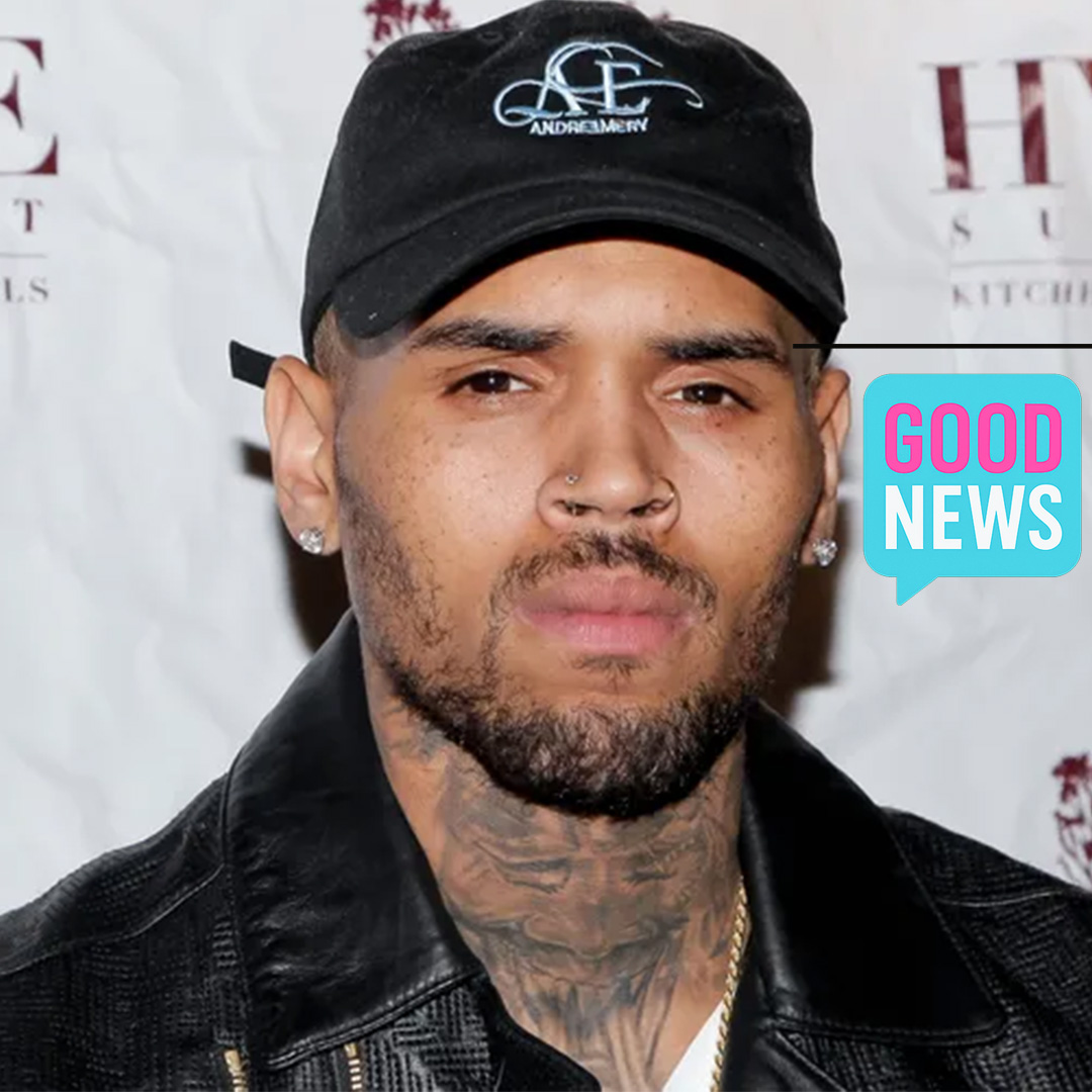 Chris Brown walking through a crowd in London, surrounded by security, amid reports of a $5 million bail in an ongoing assault case.