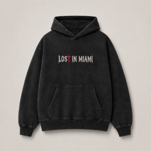 Front view of Lost in Miami God Is Real heavyweight washed-black hoodie with Gothic chest logo and neon-pink cross T